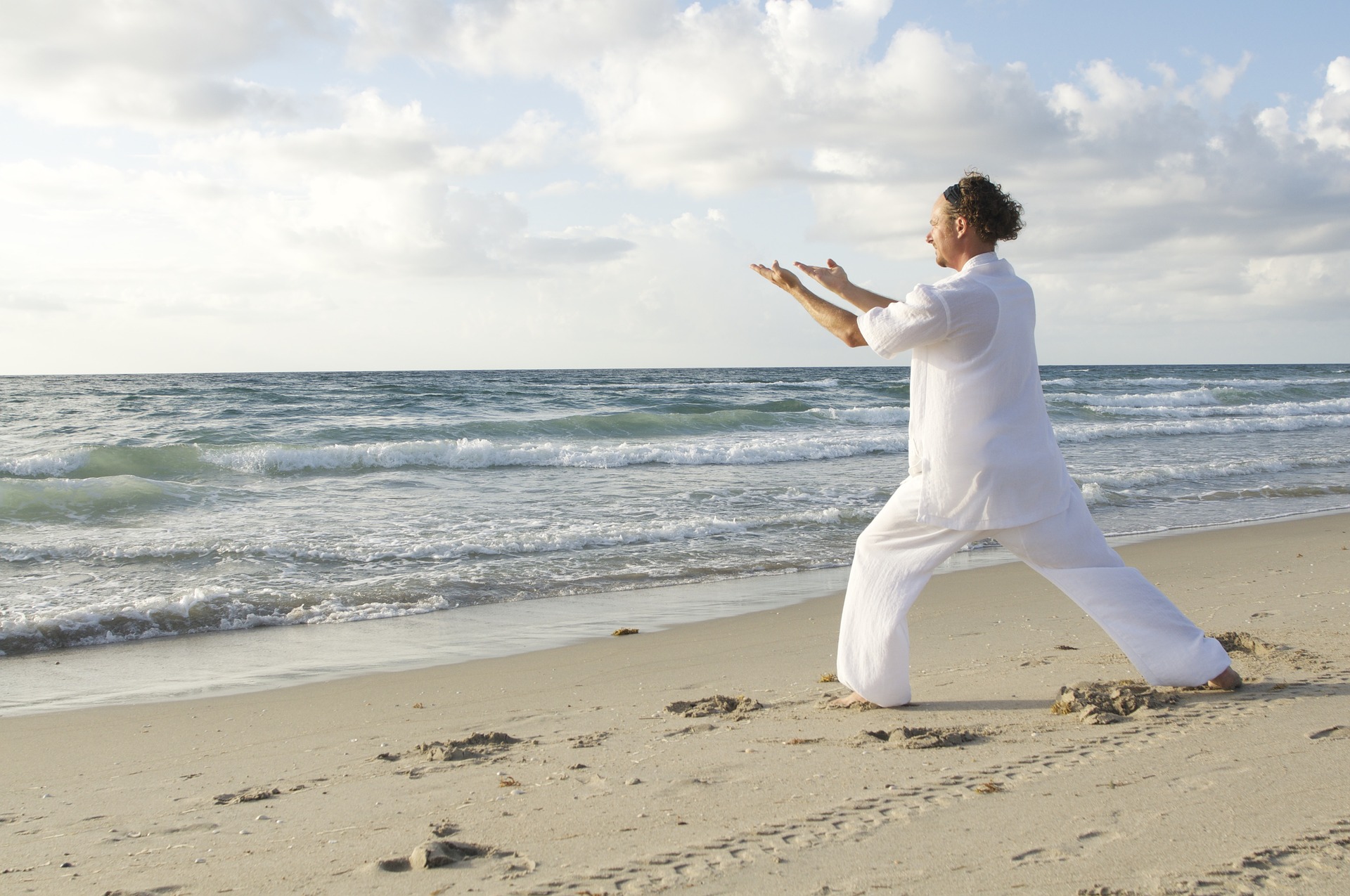 person practicing martial arts on the beach